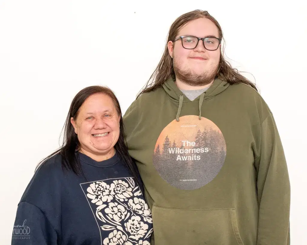 Two people smiling at the camera